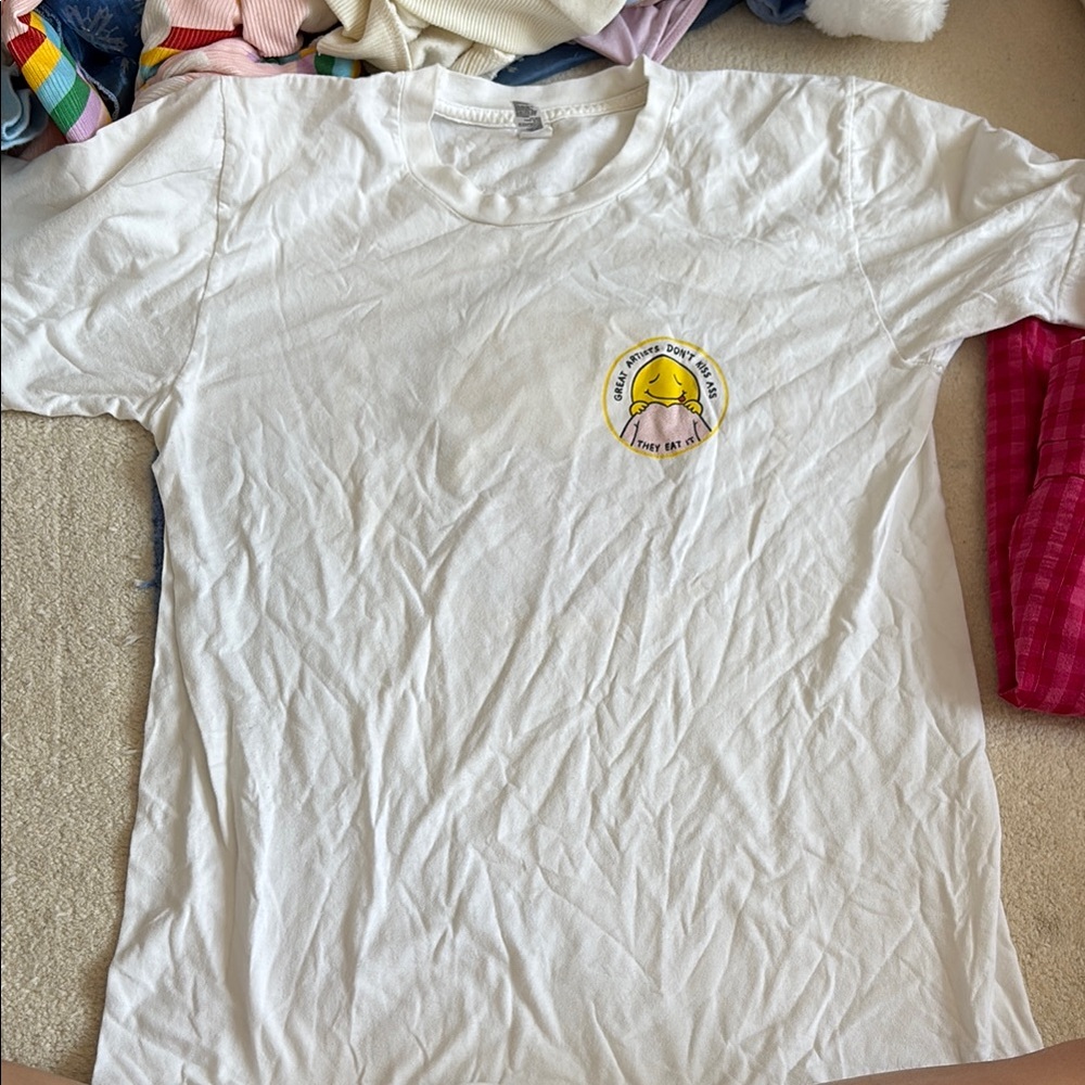 White shirt with smiley graphic